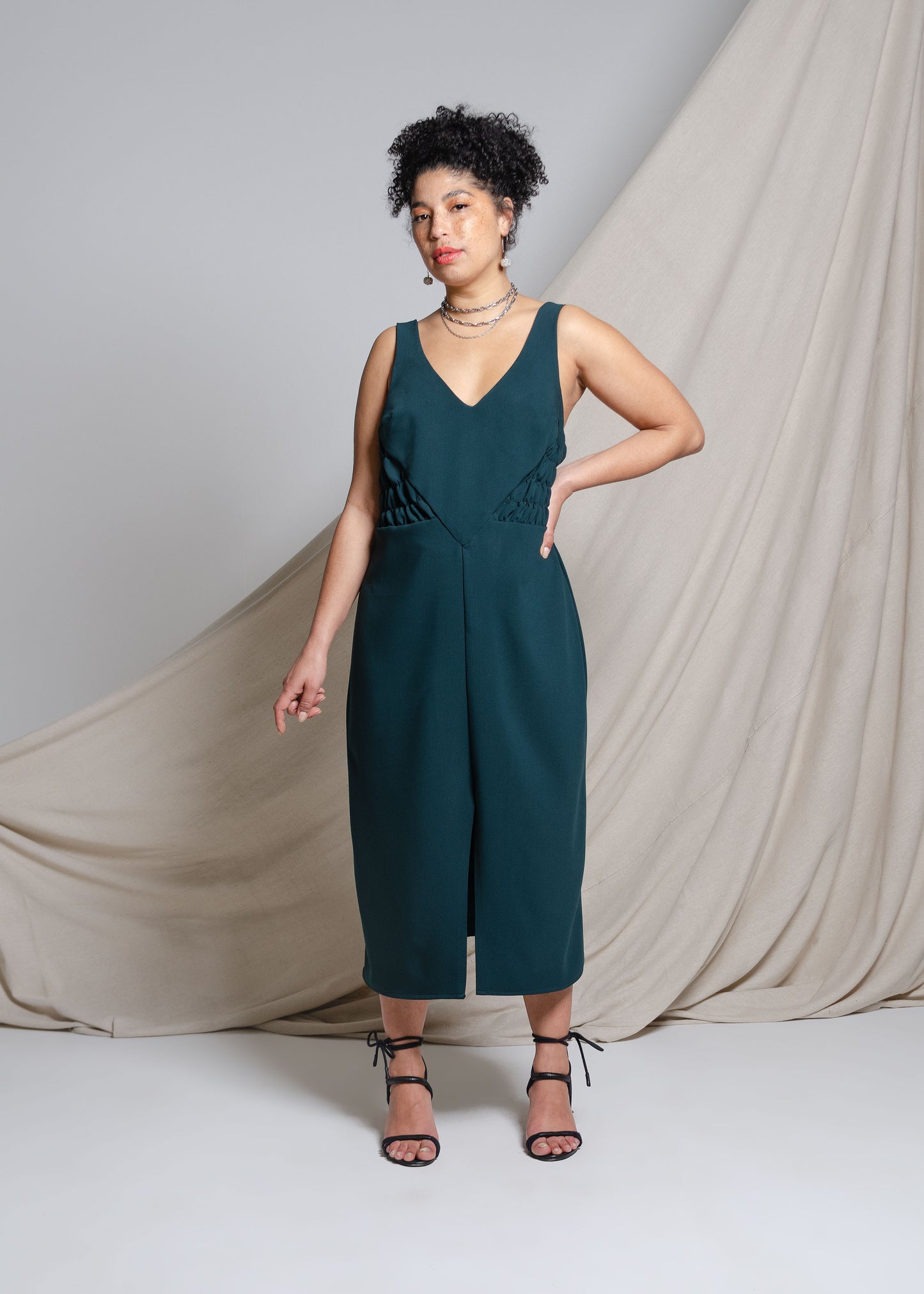 Form skimming Midi length A-line dress with gathered side panels and very low back. Forest green double weave fabric.
