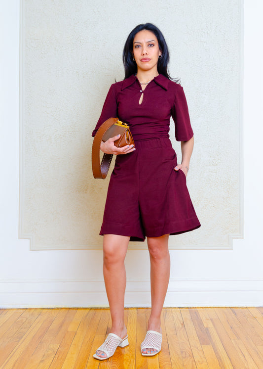 Pull-on stretch knit "jorts" with elasticized waistband, gathering detail at hips, side seam pockets & slightly flared hem to give the illusion of a skirt. The wide hem helps keep a nice, crisp edge while not sacrificing the fabric's drape. Length hits several inches above the knee, 

The colour is a rich chocolate brown with slightly purple undertones.

Styled with matching collared t-shirt with flared 3/4 length sleeves, exaggerated collar, rouched side seams & keyhole & button front neck closure
